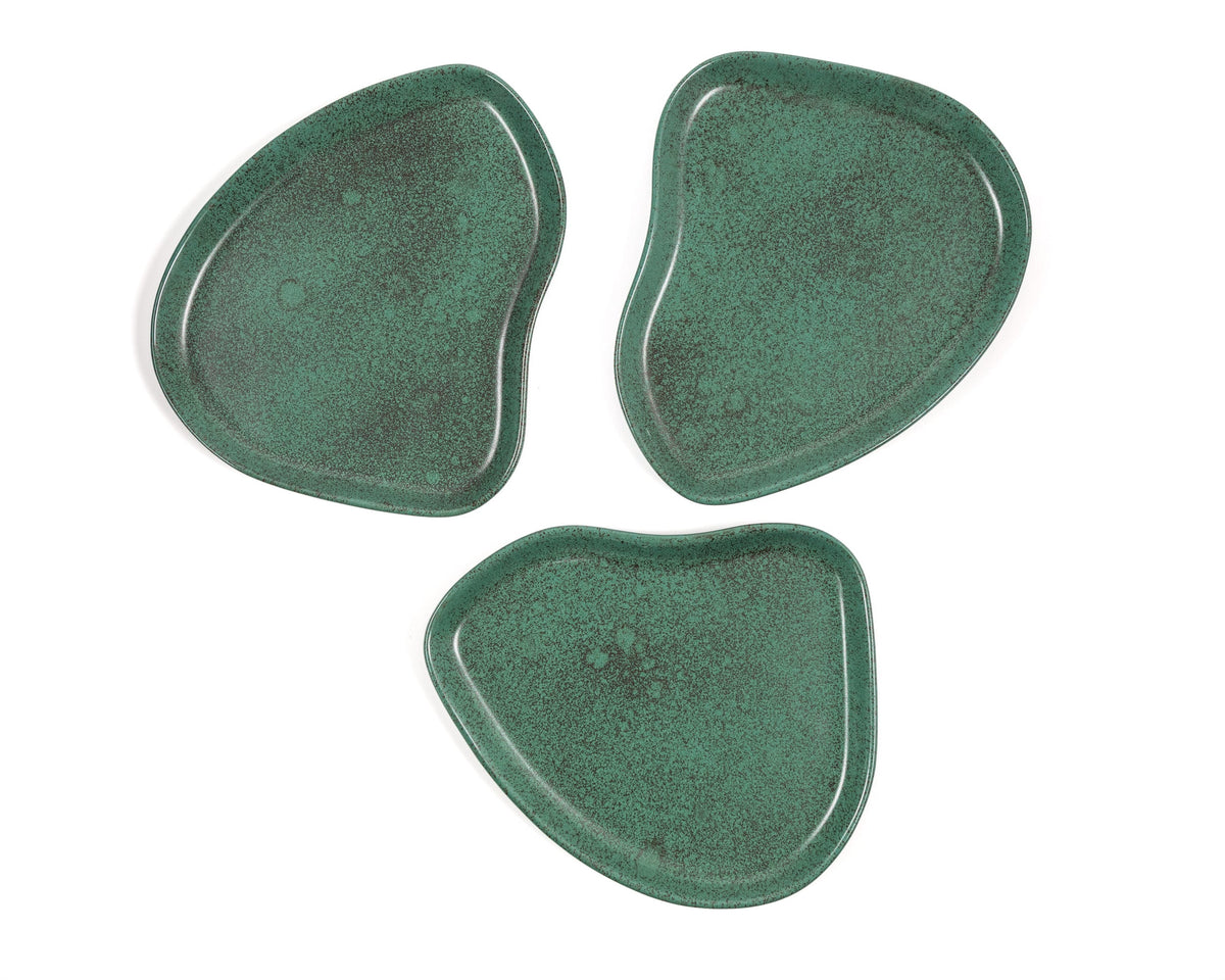 Three green ceramic coasters on a white background