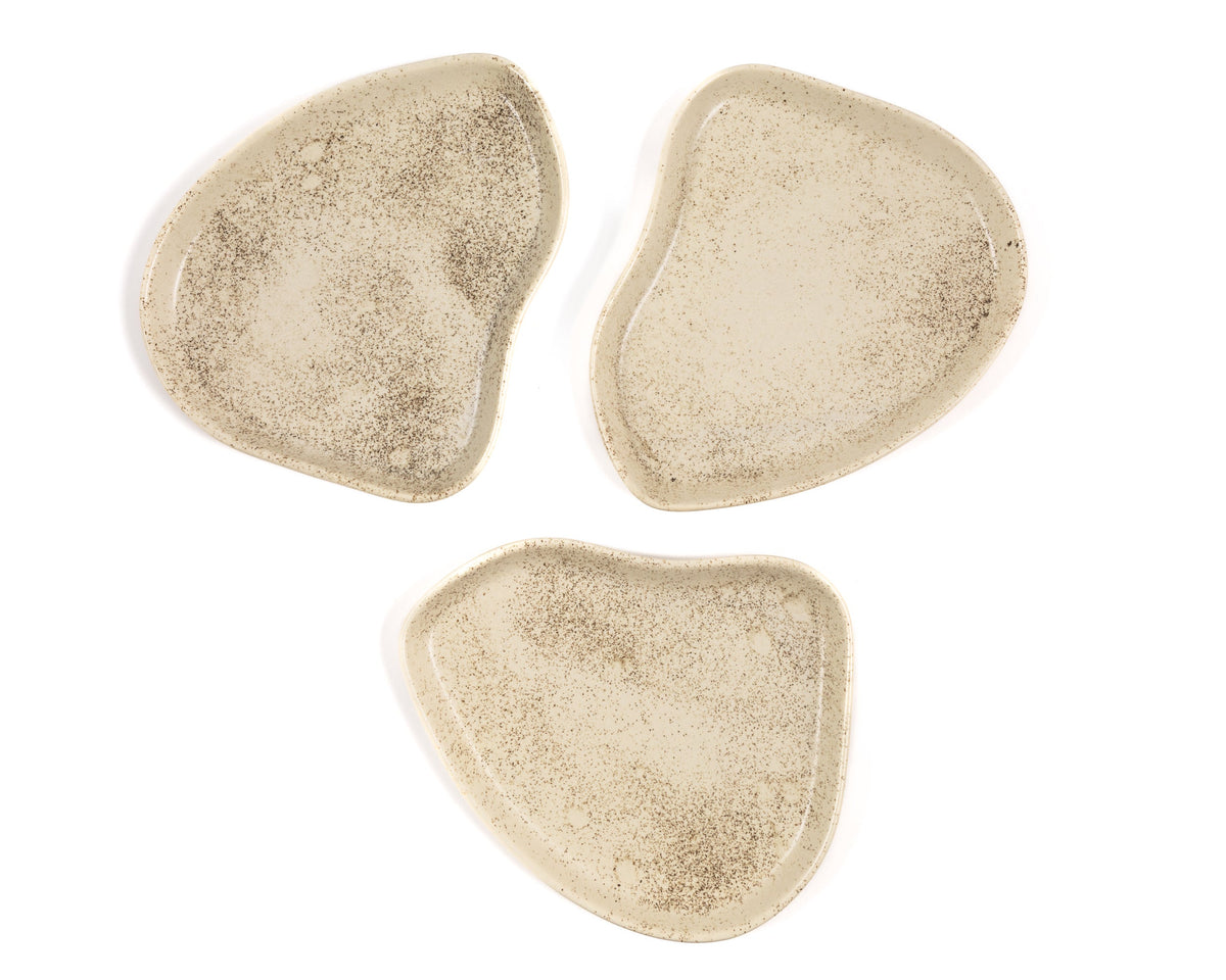 Three beige plates on a white background