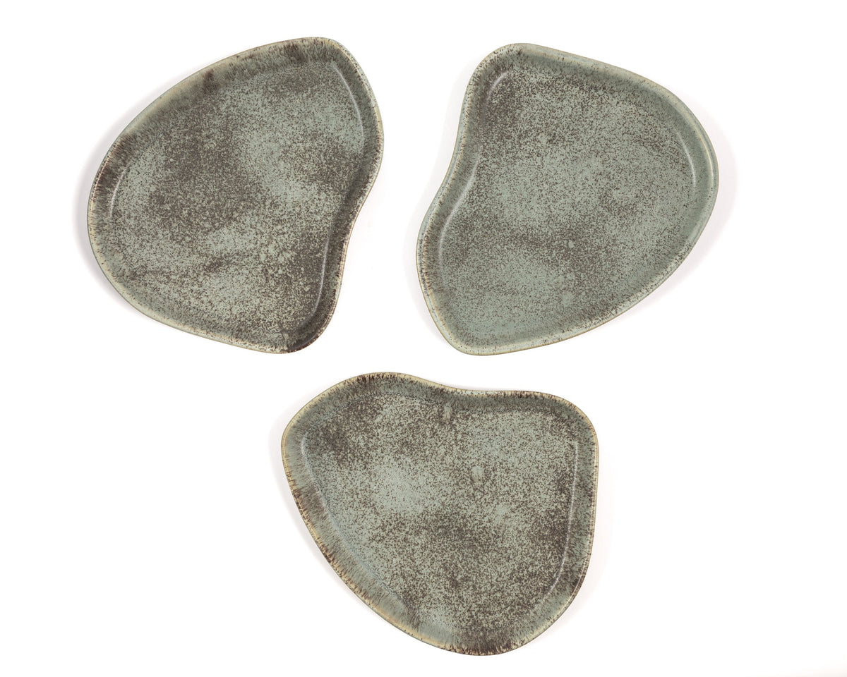Three green ceramic coasters on a white background