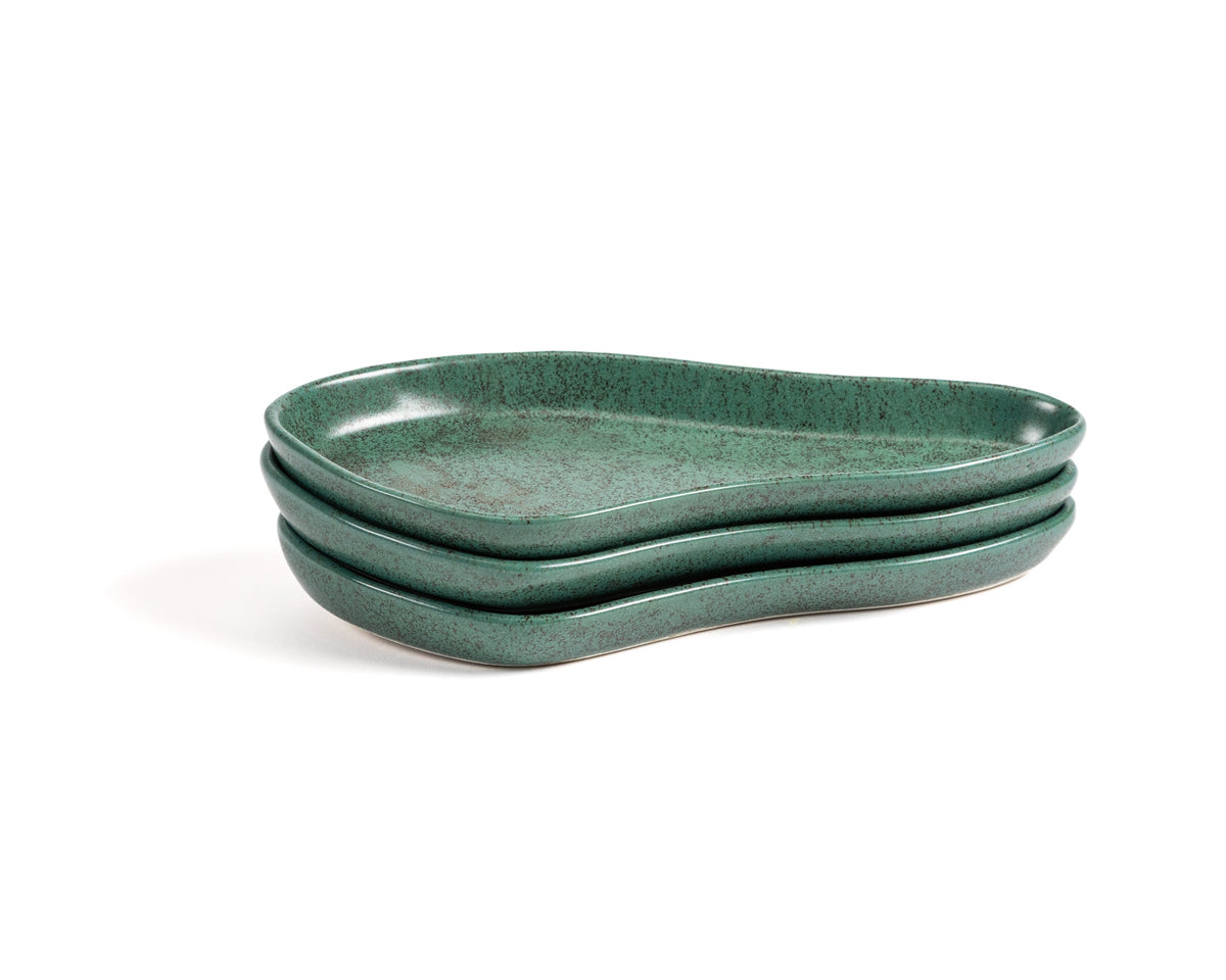 Three green ceramic trays stacked on a white background