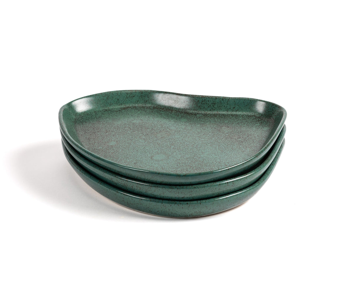 Set of three green ceramic plates on a white background