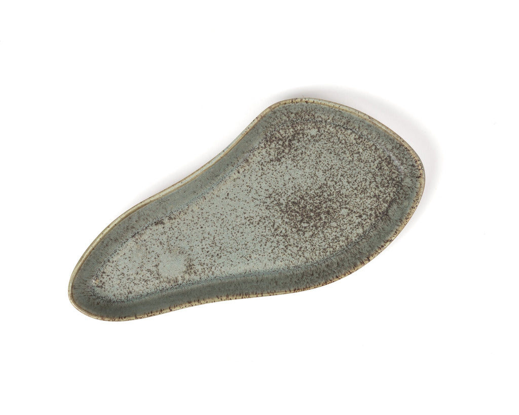 Speckled green ceramic plate on a white background