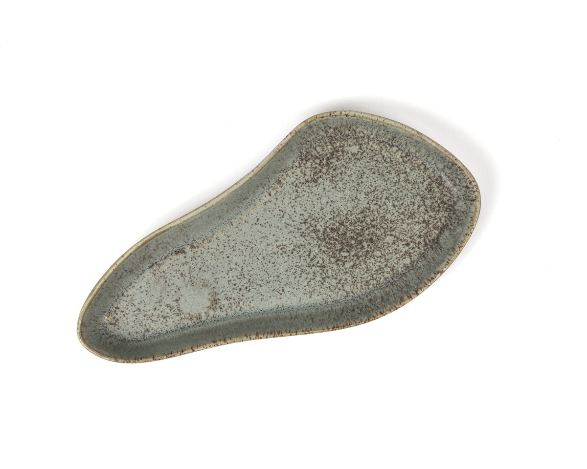 Speckled green ceramic plate on a white background