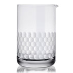 Clear cocktail mixing glass with honeycomb pattern on a white background