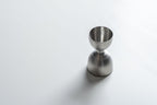 Metallic jigger on a white background