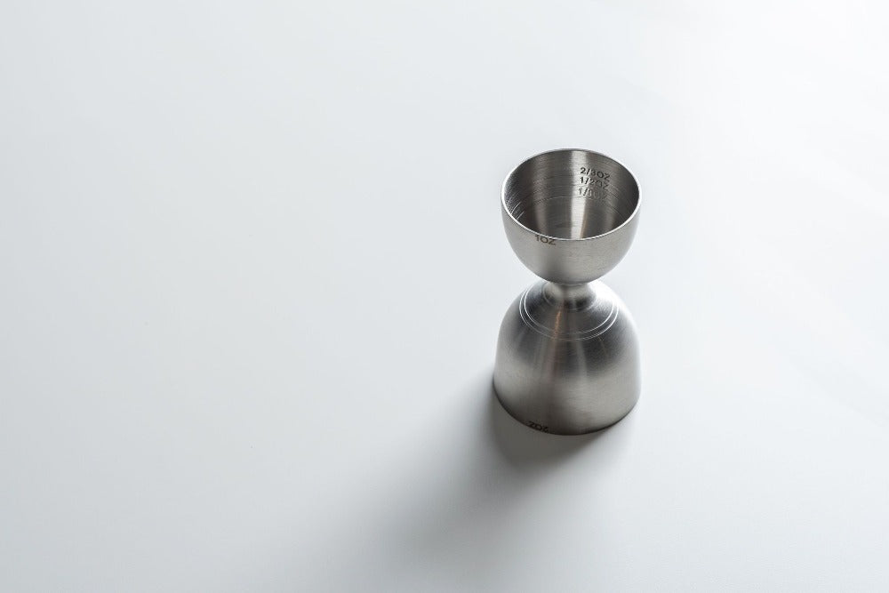 Metallic jigger on a white background