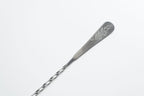 Silver spoon with engraved design on a white background