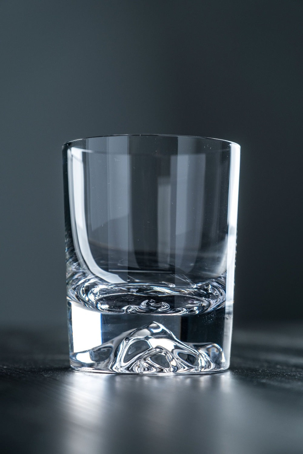 Clear glass tumbler on a dark background