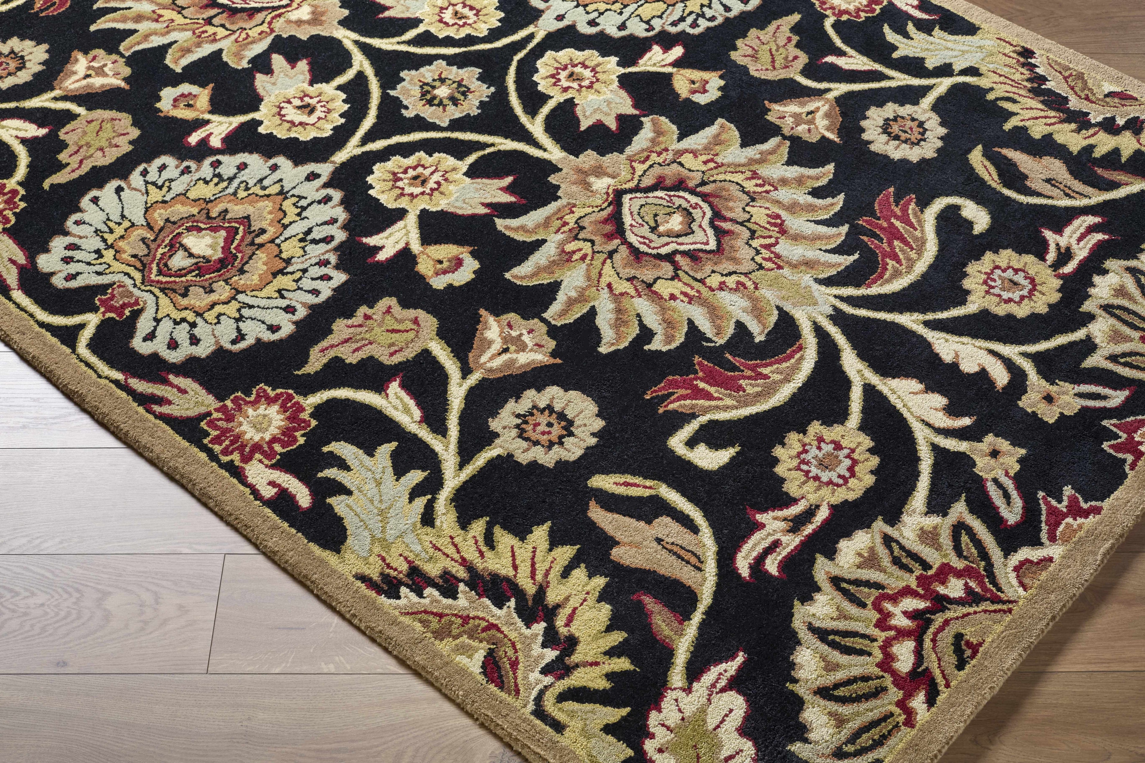 Decorative floral rug on a wooden floor