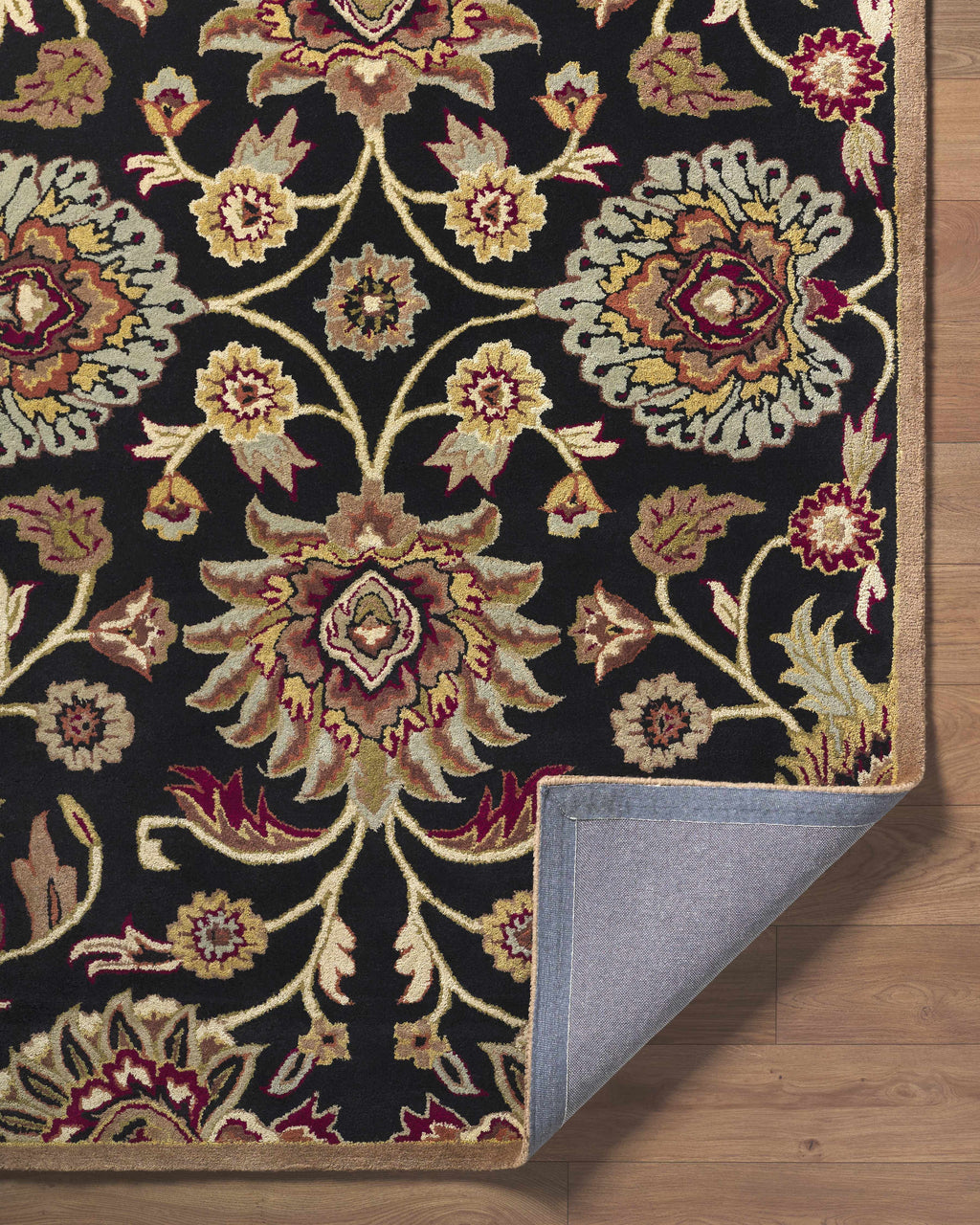 Decorative rug with intricate floral pattern on a wooden floor