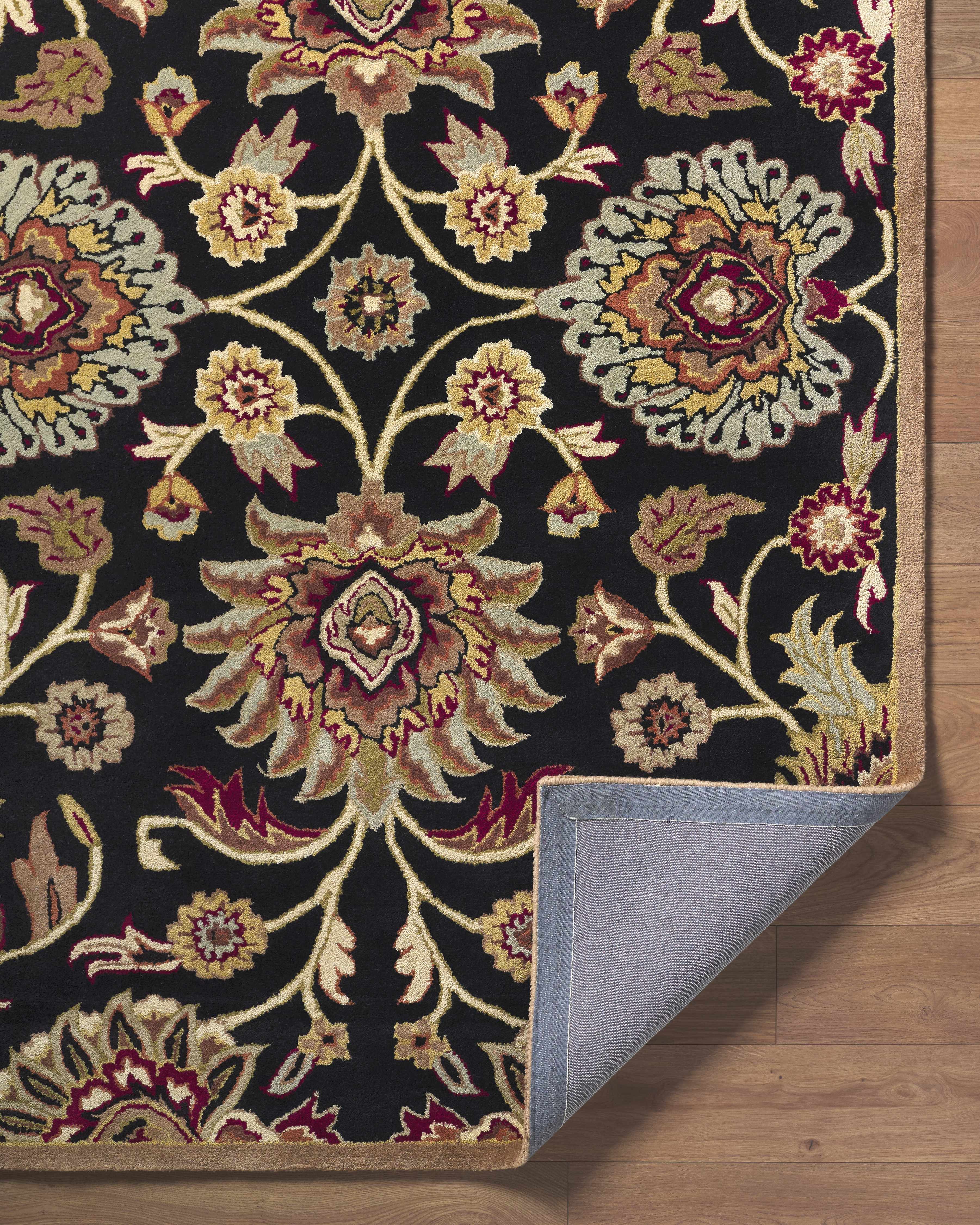 Decorative rug with intricate floral pattern on a wooden floor