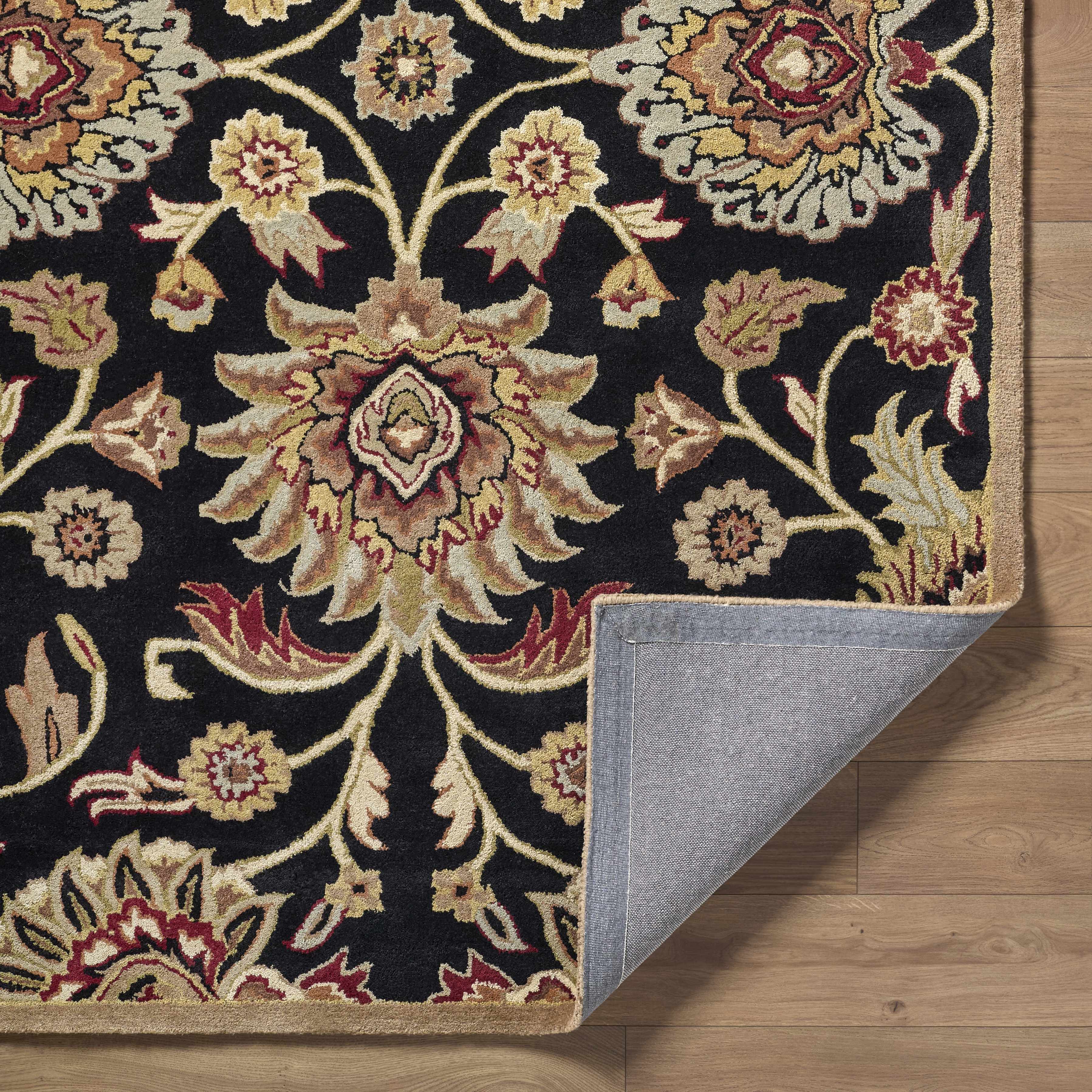 Decorative rug with intricate patterns on a wooden floor