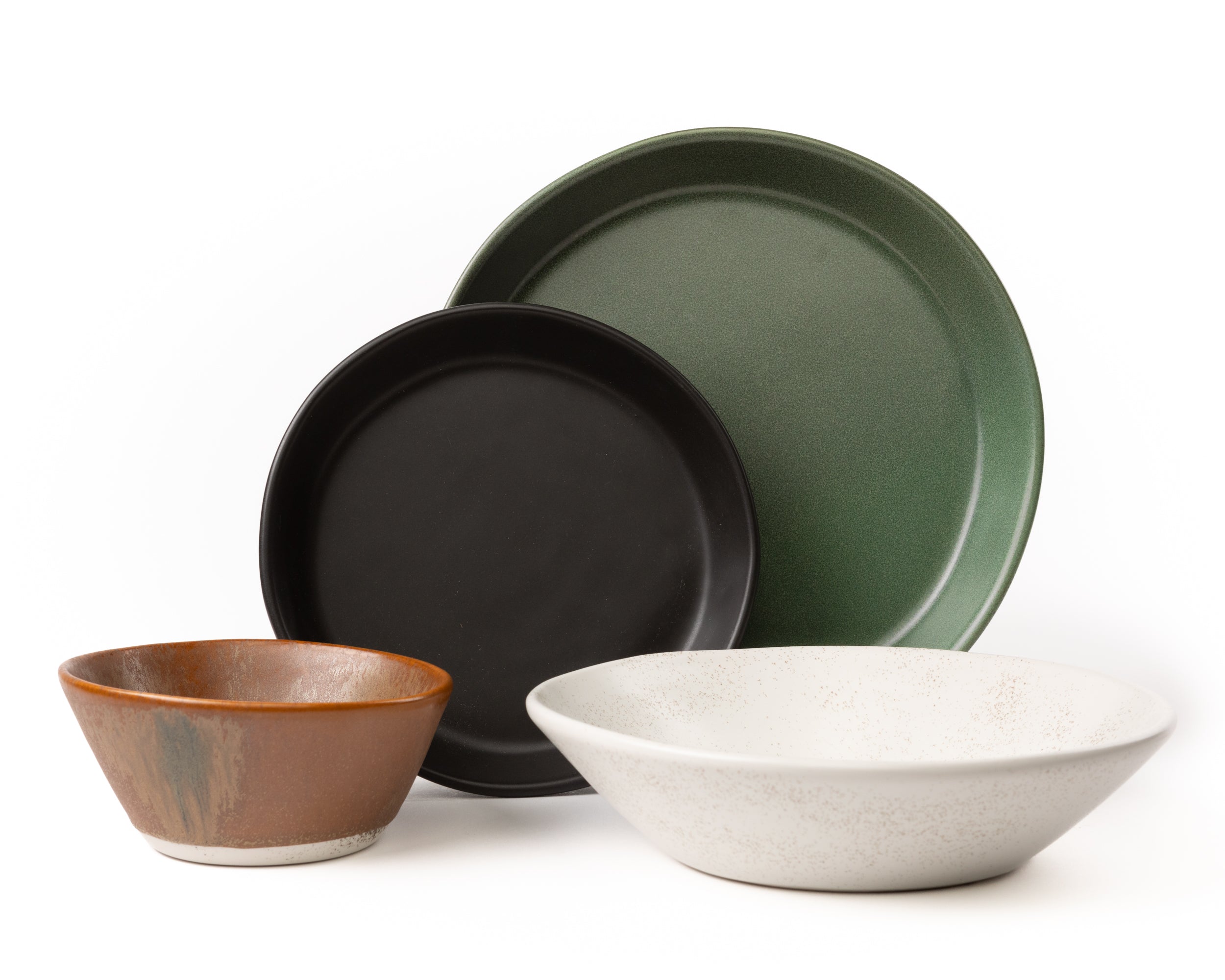 Set of ceramic bowls in various colors on a white background