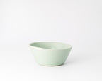 Light green ceramic bowl on a white background