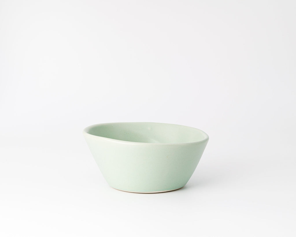 Light green ceramic bowl on a white background