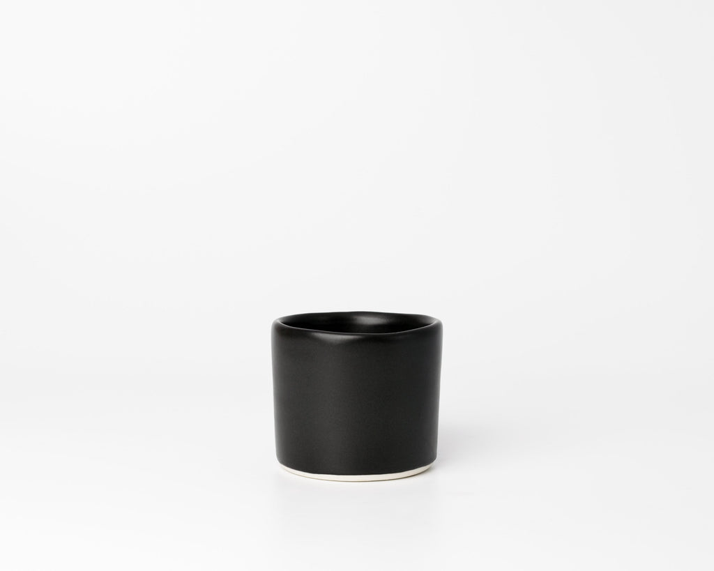 Black ceramic cup on a white background
