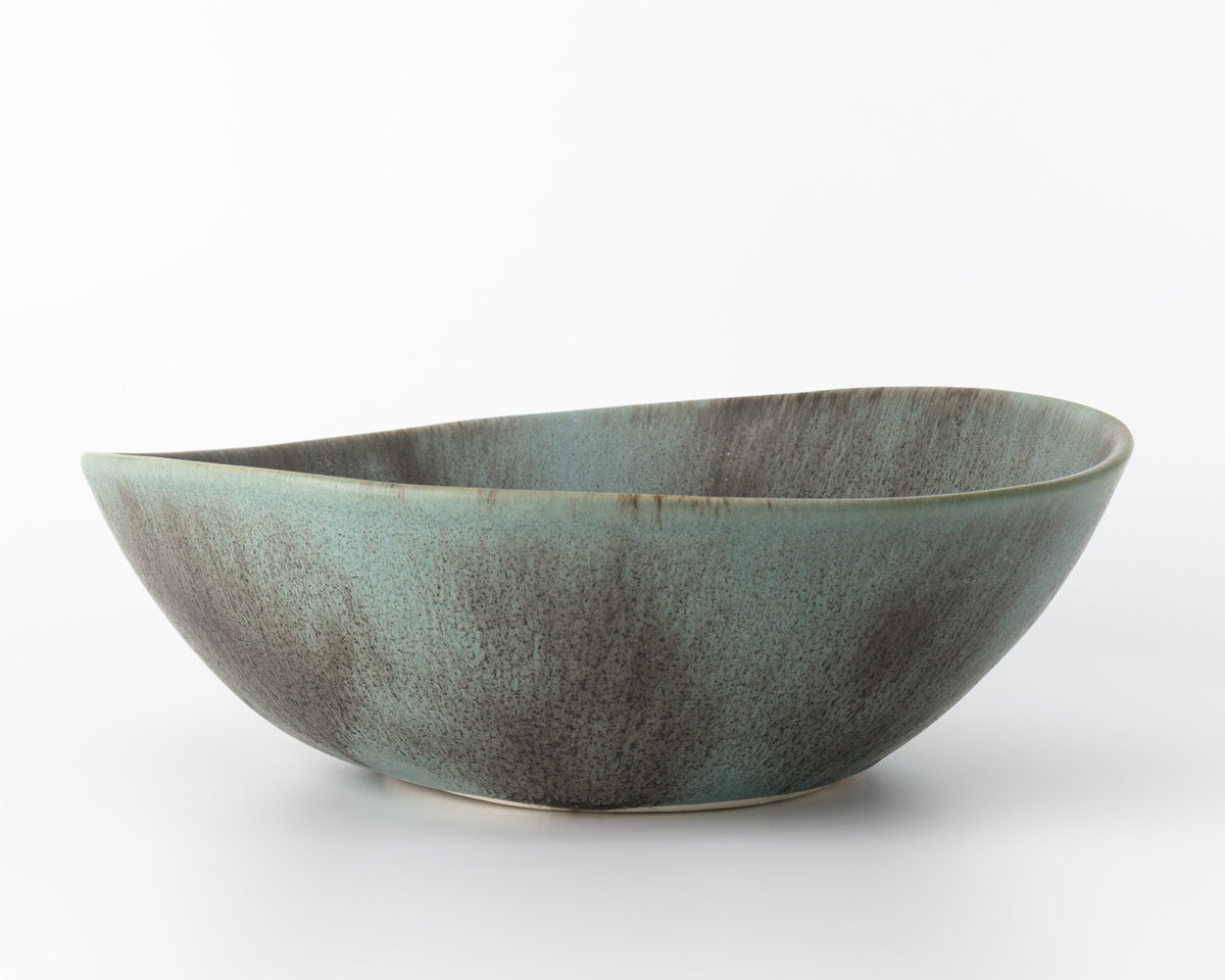 Green ceramic bowl on a white background
