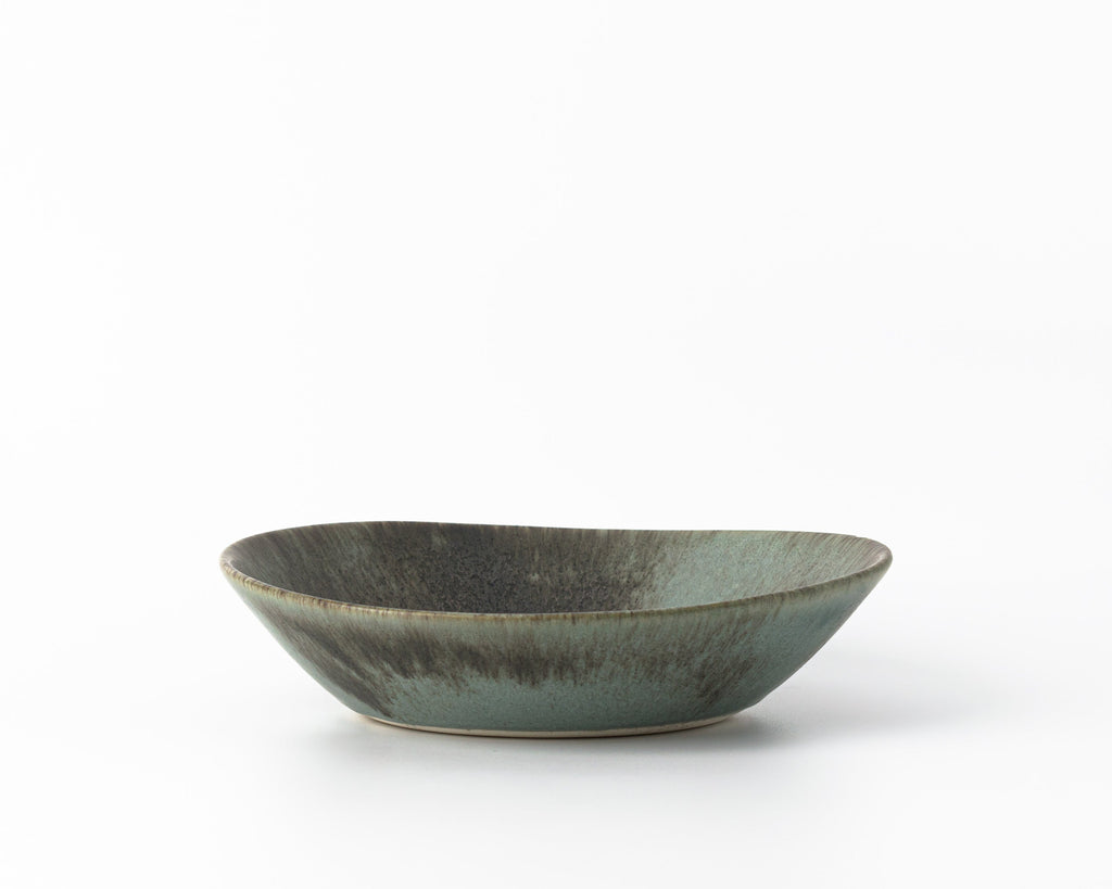 Ceramic bowl with a textured surface on a white background