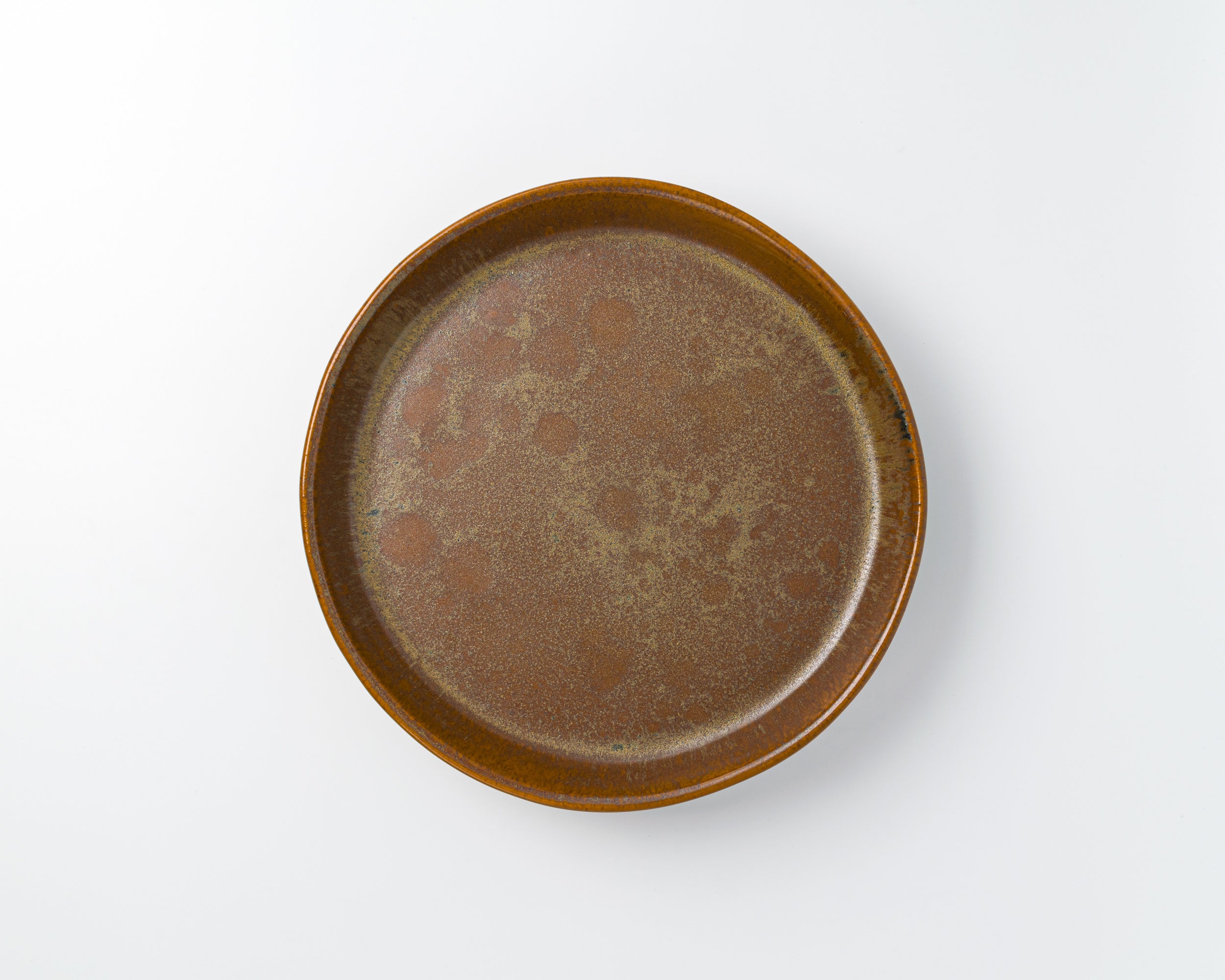 Brown ceramic plate on a white background