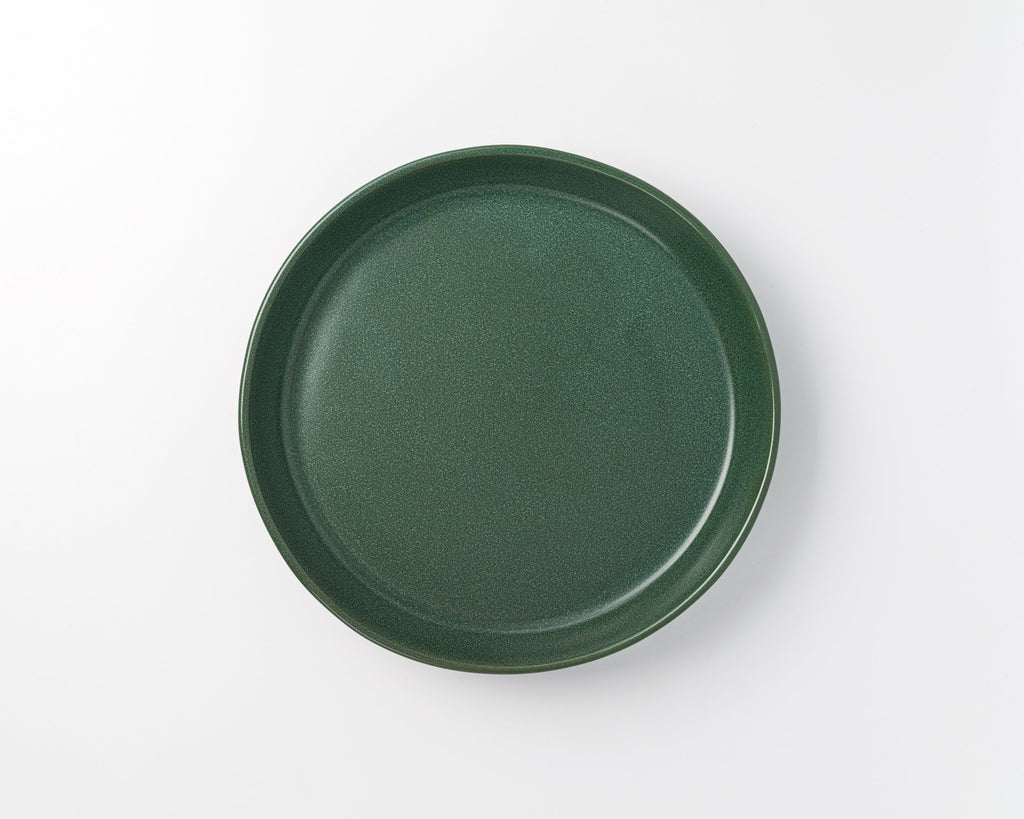 Green ceramic plate on a white background