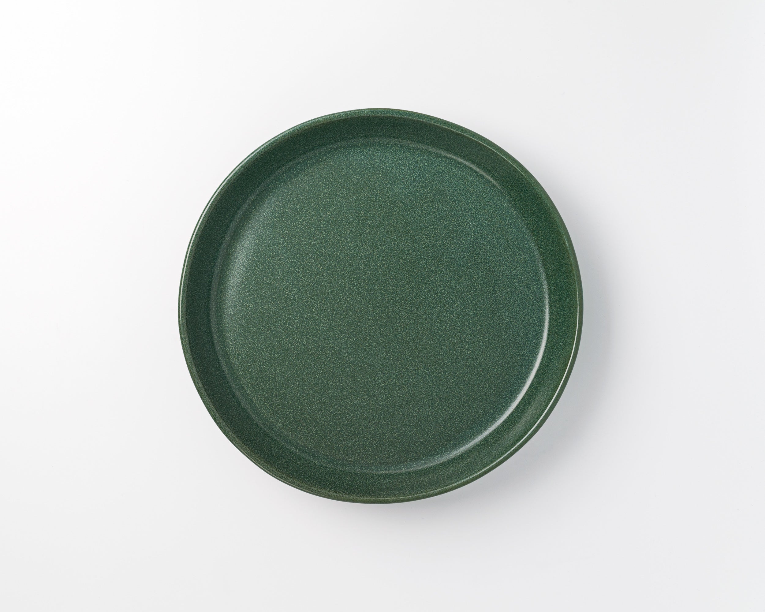 Green ceramic plate on a white background