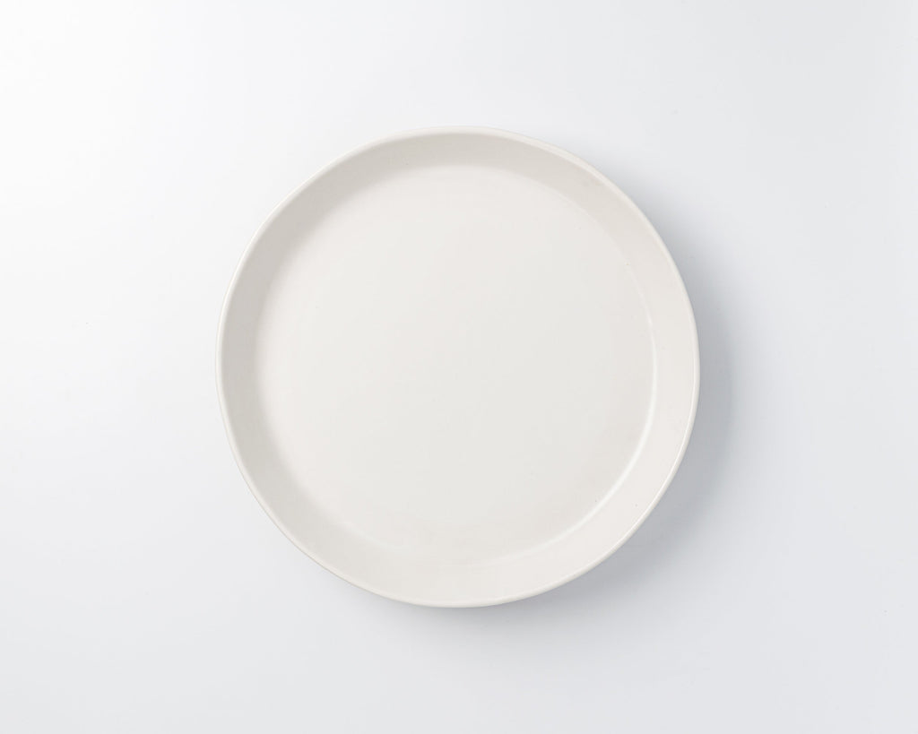 White ceramic plate on a light gray background