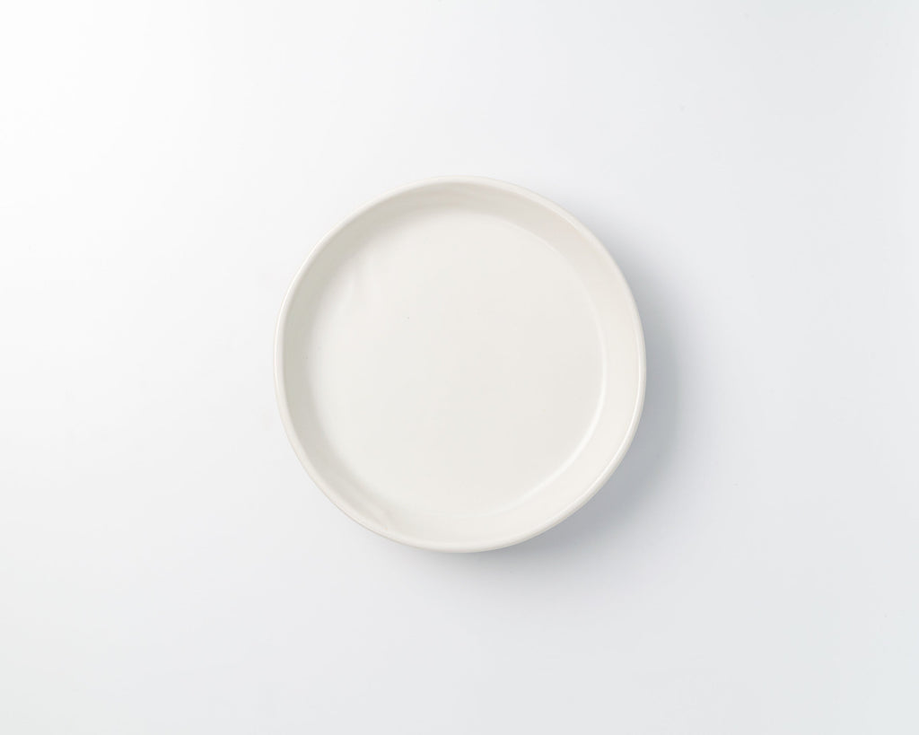 White ceramic plate on a light gray background