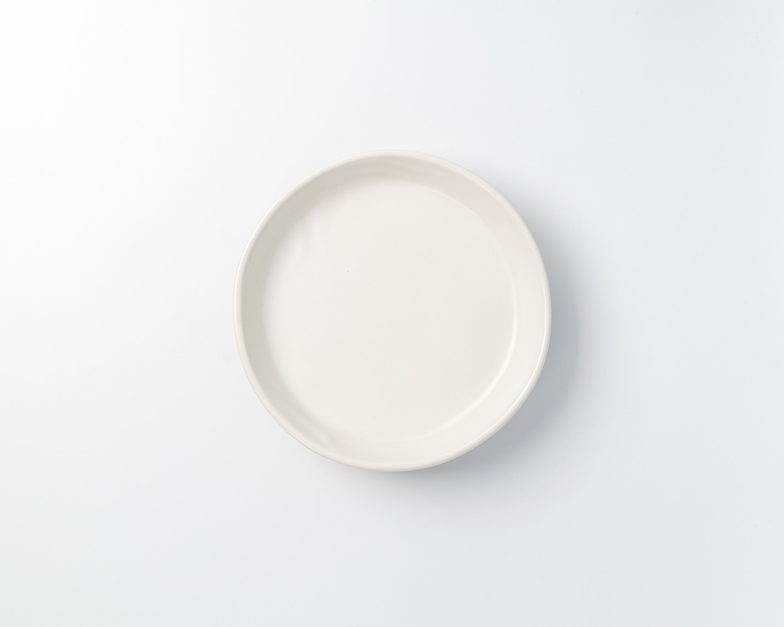 White ceramic plate on a light gray background