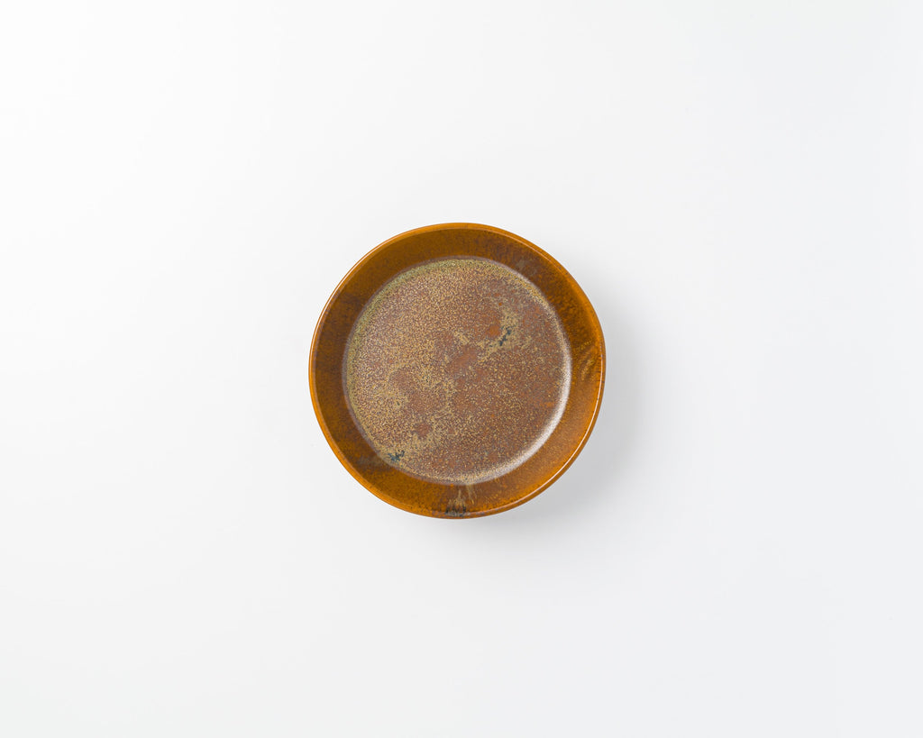 Small brown ceramic dish on a white background