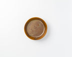 Small brown ceramic dish on a white background