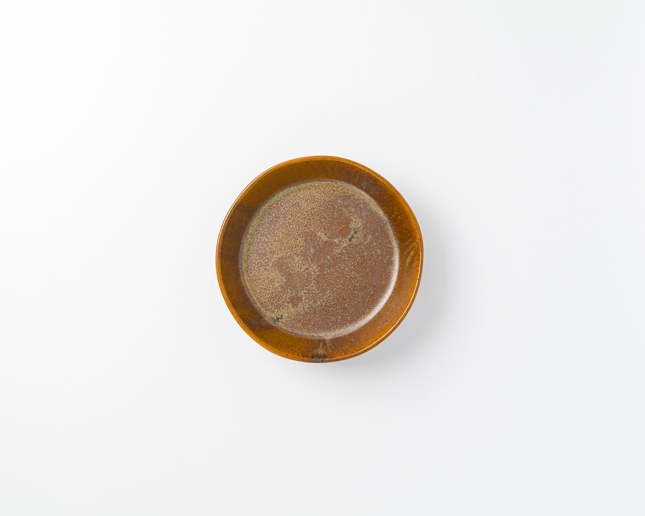 Small brown ceramic dish on a white background