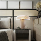Modern bedroom with a bed, nightstand, and decorative lamp.