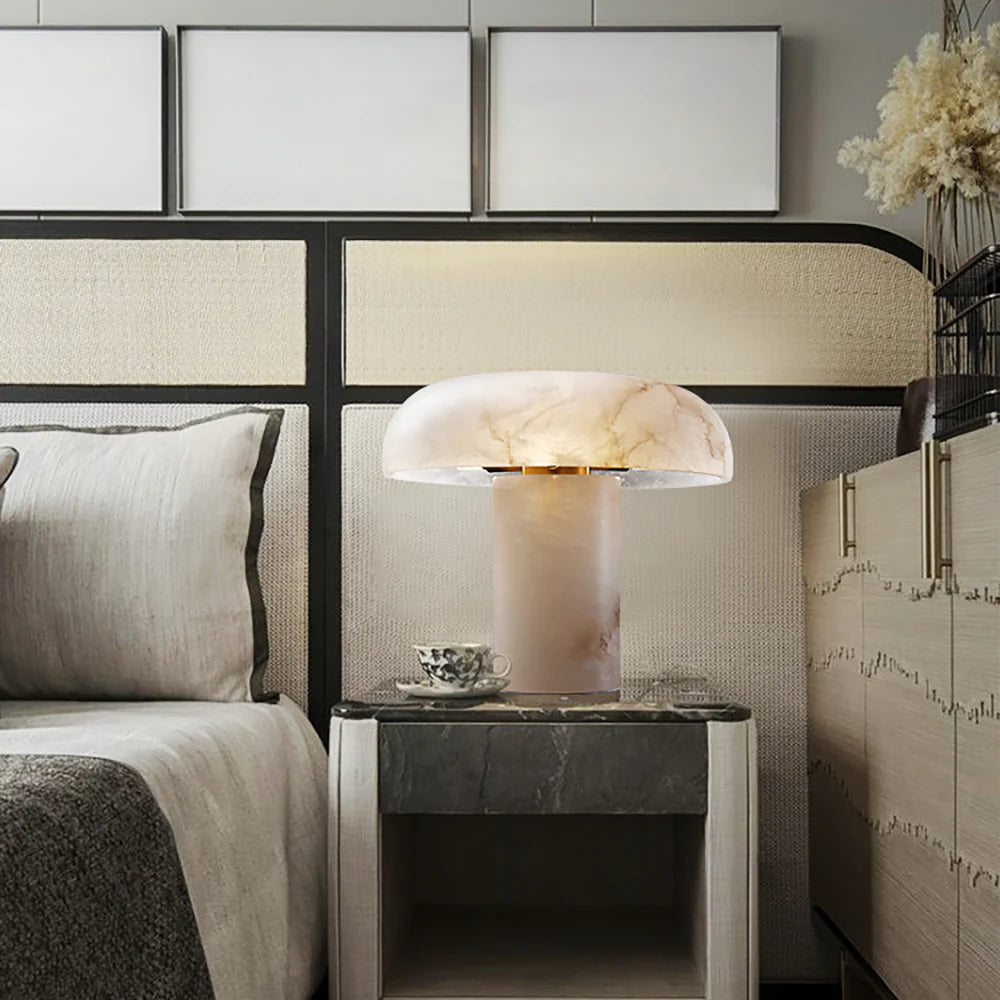 Modern bedroom with a bed, nightstand, and decorative lamp.