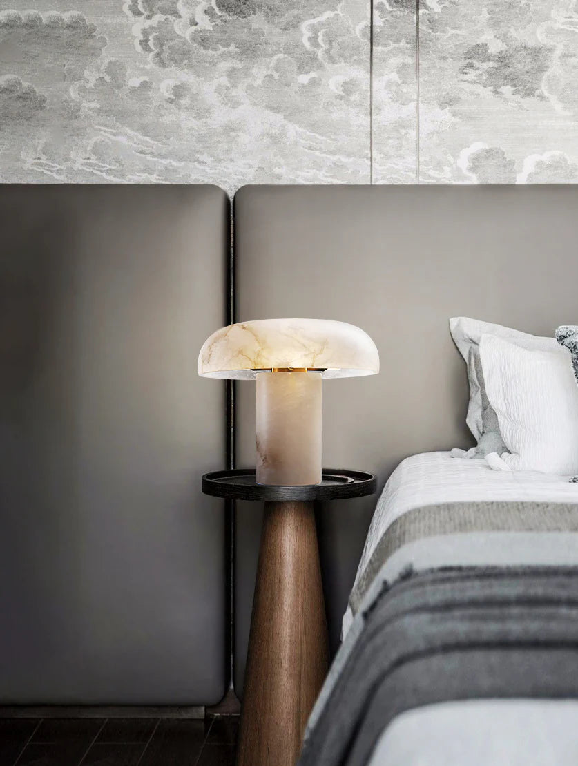 Modern bedroom with a bed, nightstand, and decorative lamp.