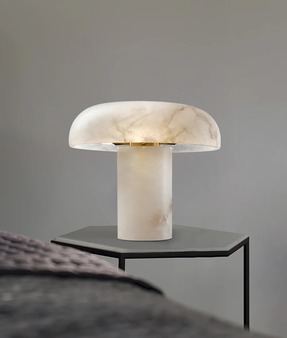 Marble-textured table lamp on a side table against a gray wall