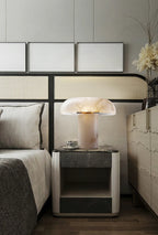 Modern bedroom with a bed, nightstand, and decorative elements.