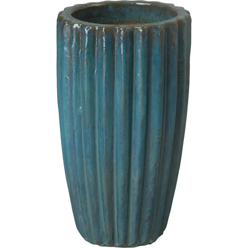 Blue ceramic planter with ribbed texture on a white background