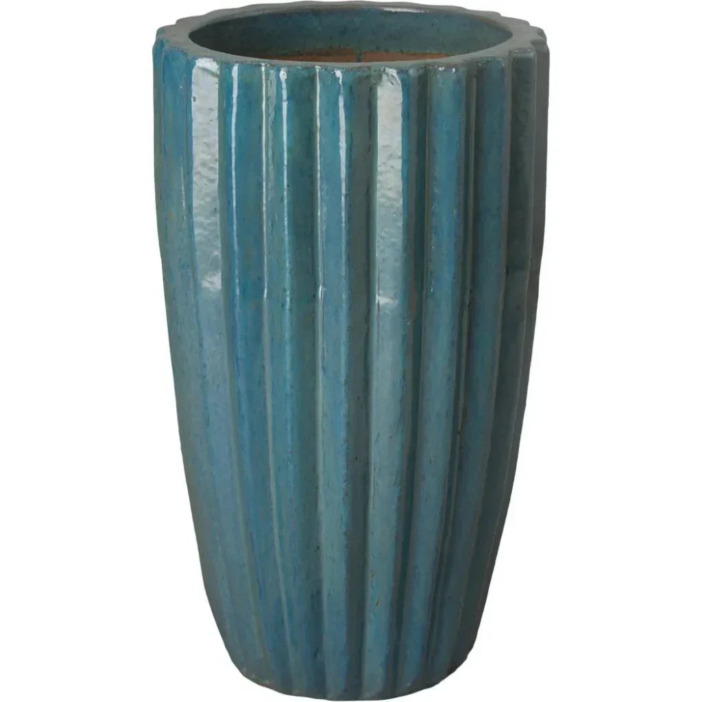 Blue ribbed ceramic planter on a white background