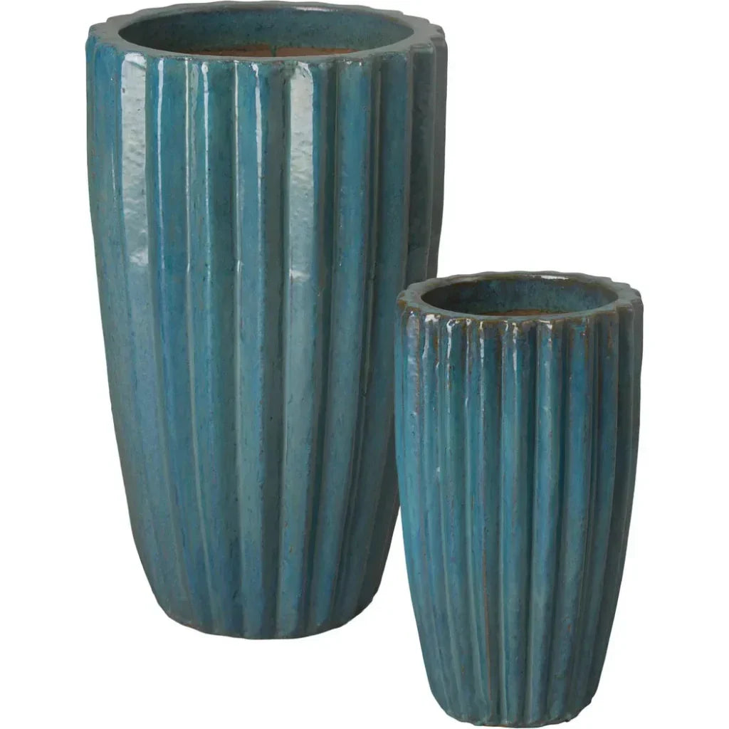 Two blue ceramic planters with ribbed texture on a white background