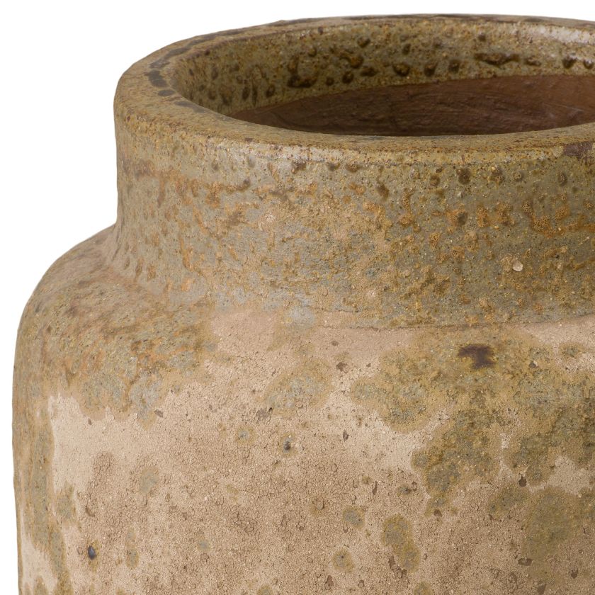 Close-up of a textured ceramic pot with a neutral color palette.
