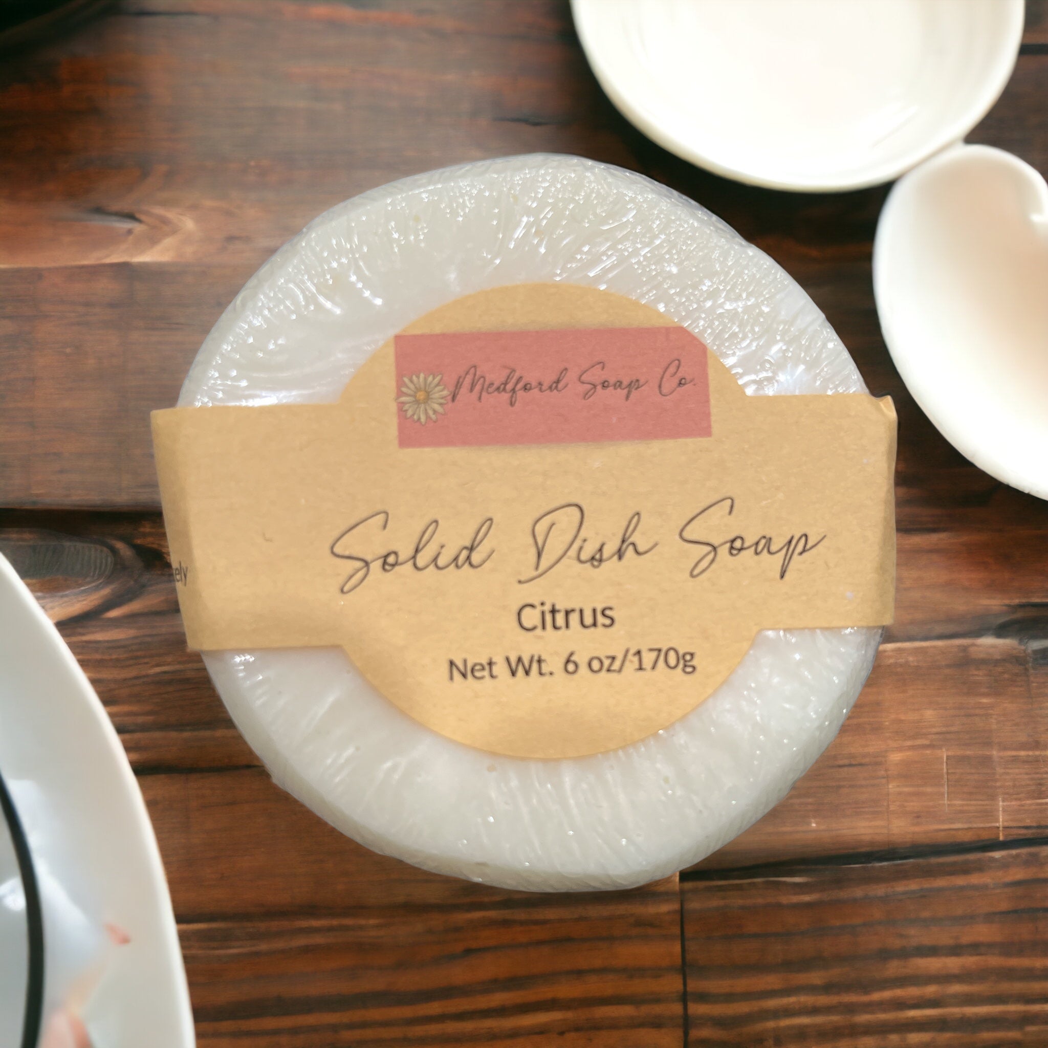 Solid dish soap bar with a label on a wooden surface