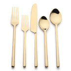 Set of gold-plated cutlery including a fork, knife, and two spoons on a white background.
