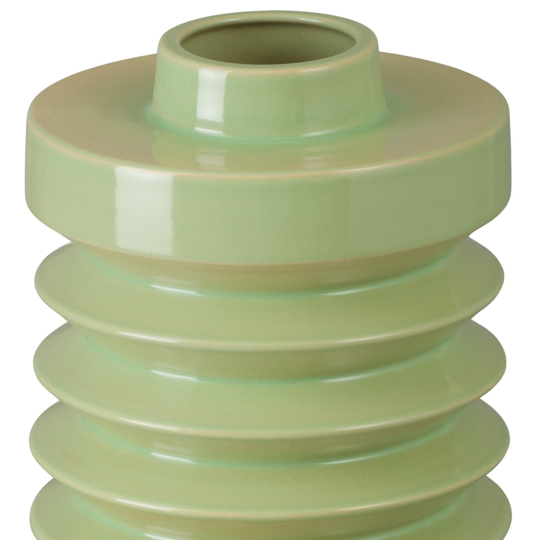 Green ceramic vase with ribbed design on a white background