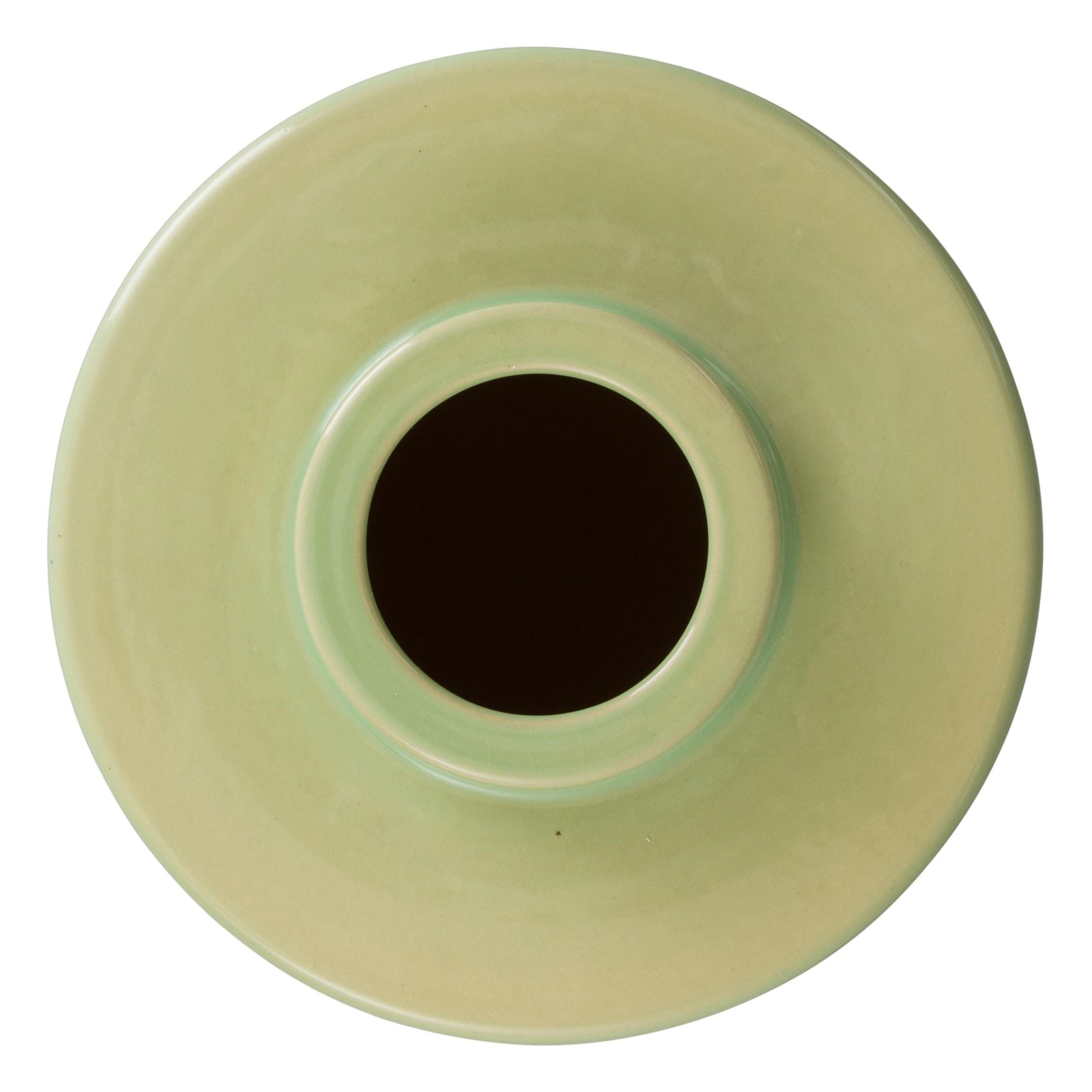 Top view of a light green ceramic vase with a dark circular center on a white background