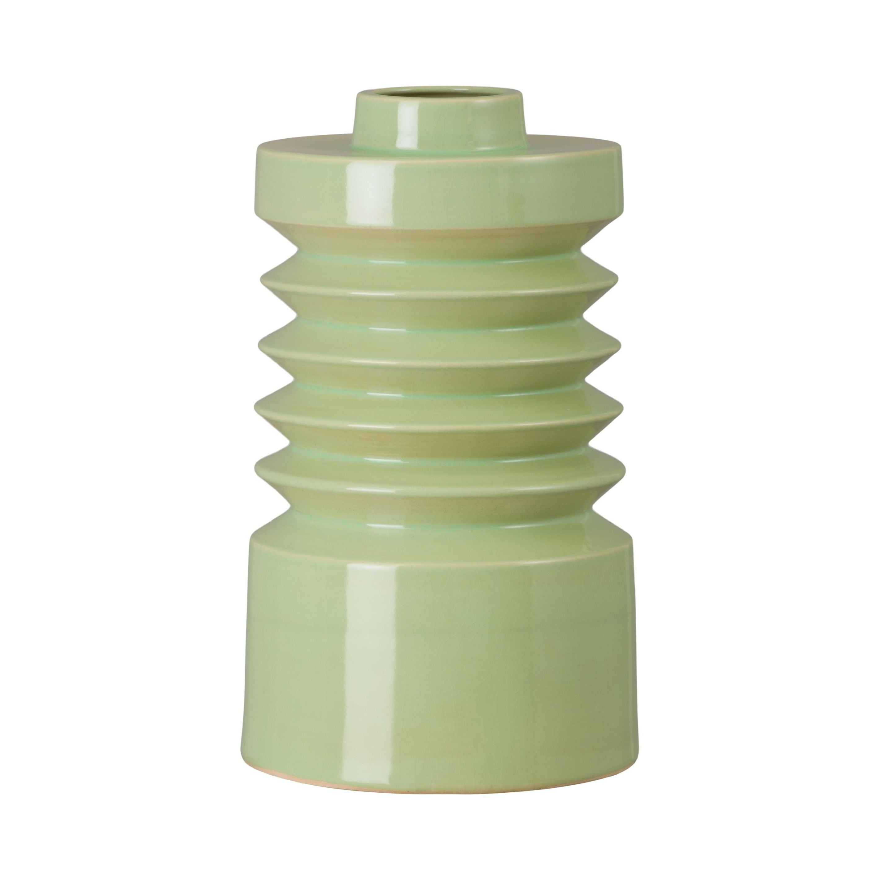 Green ceramic vase with ribbed design on a white background