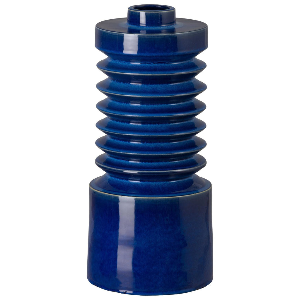 Blue ceramic vase with layered design on a white background