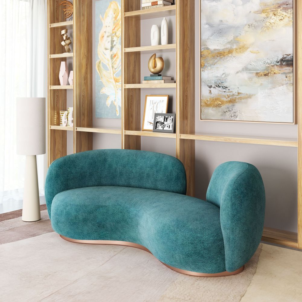 Teal sofa in a modern living room with bookshelf and abstract art