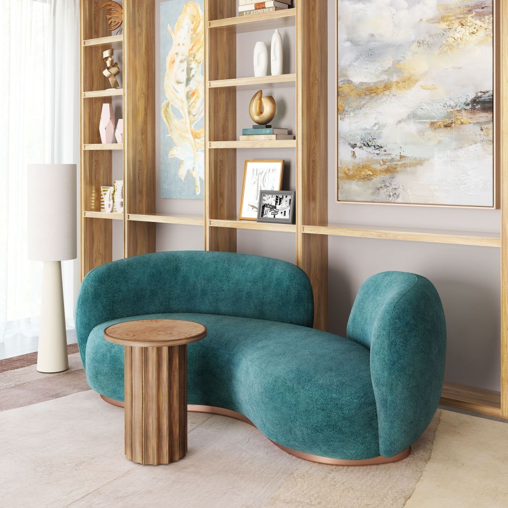 Teal sofa in a room with wooden shelves and abstract art