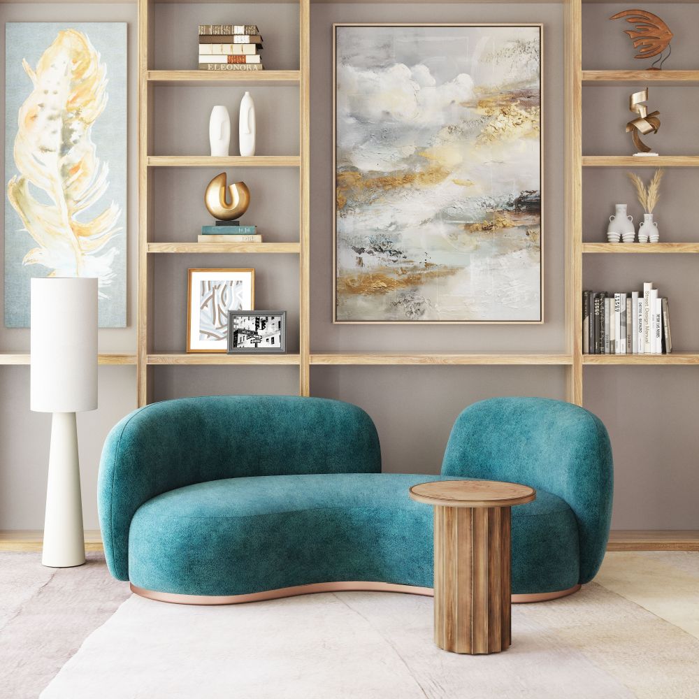 Modern living room with teal sofa, wooden side table, and abstract art on shelves.