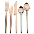 Rose gold cutlery set on a white background